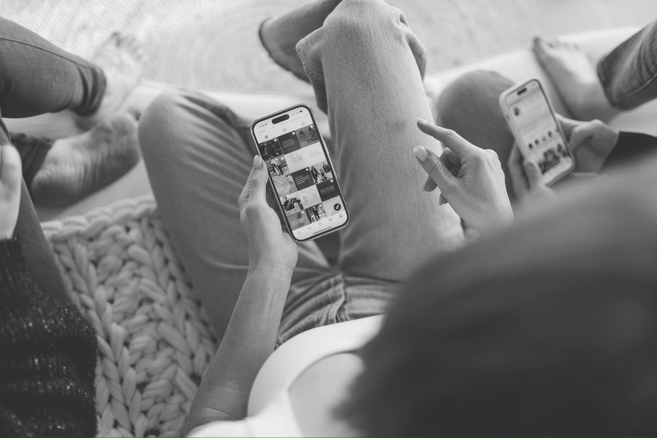 girl sitting on couch pointing at phone talking about Short-form video content creation for businesses